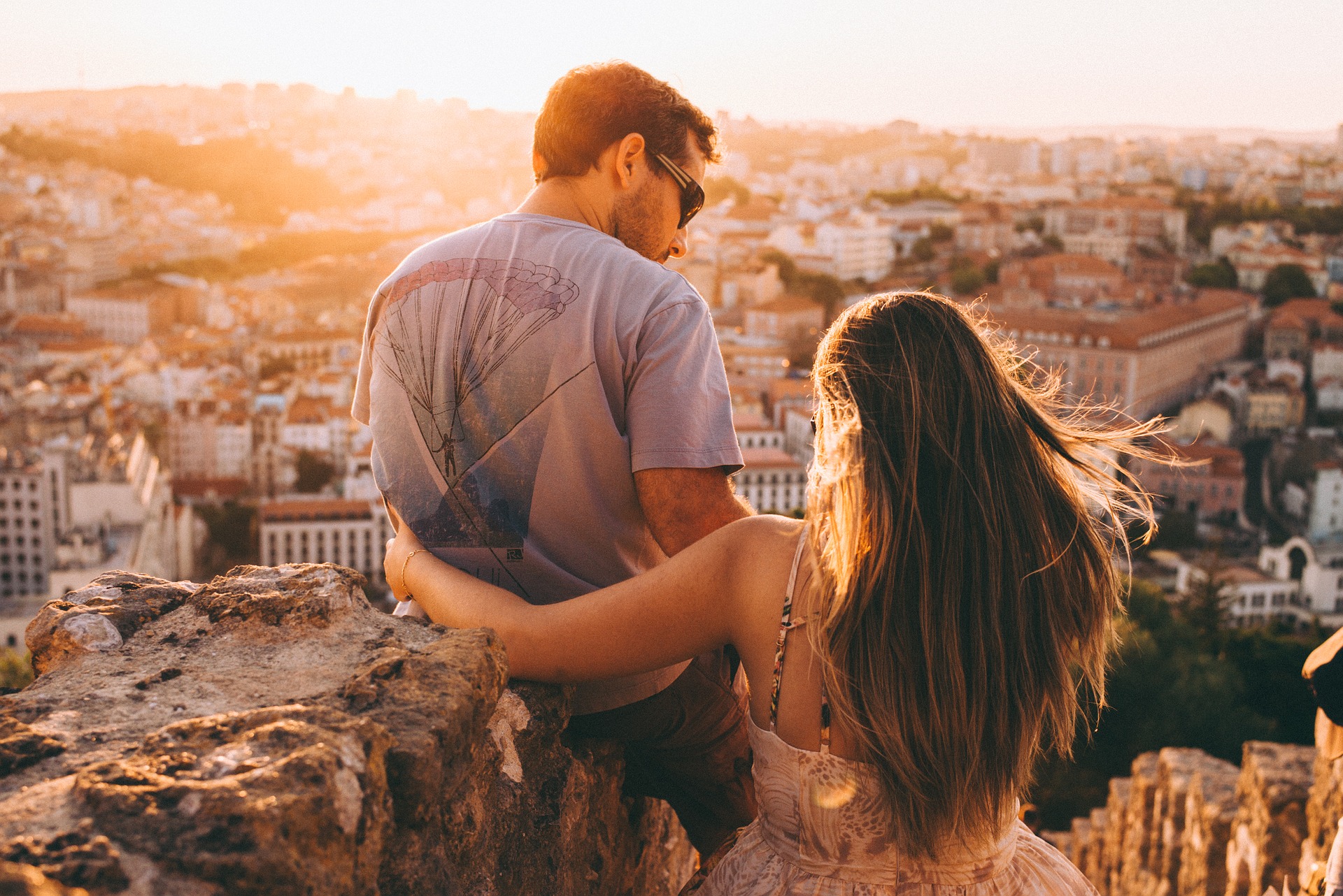 woman with arm around couple overlooking city