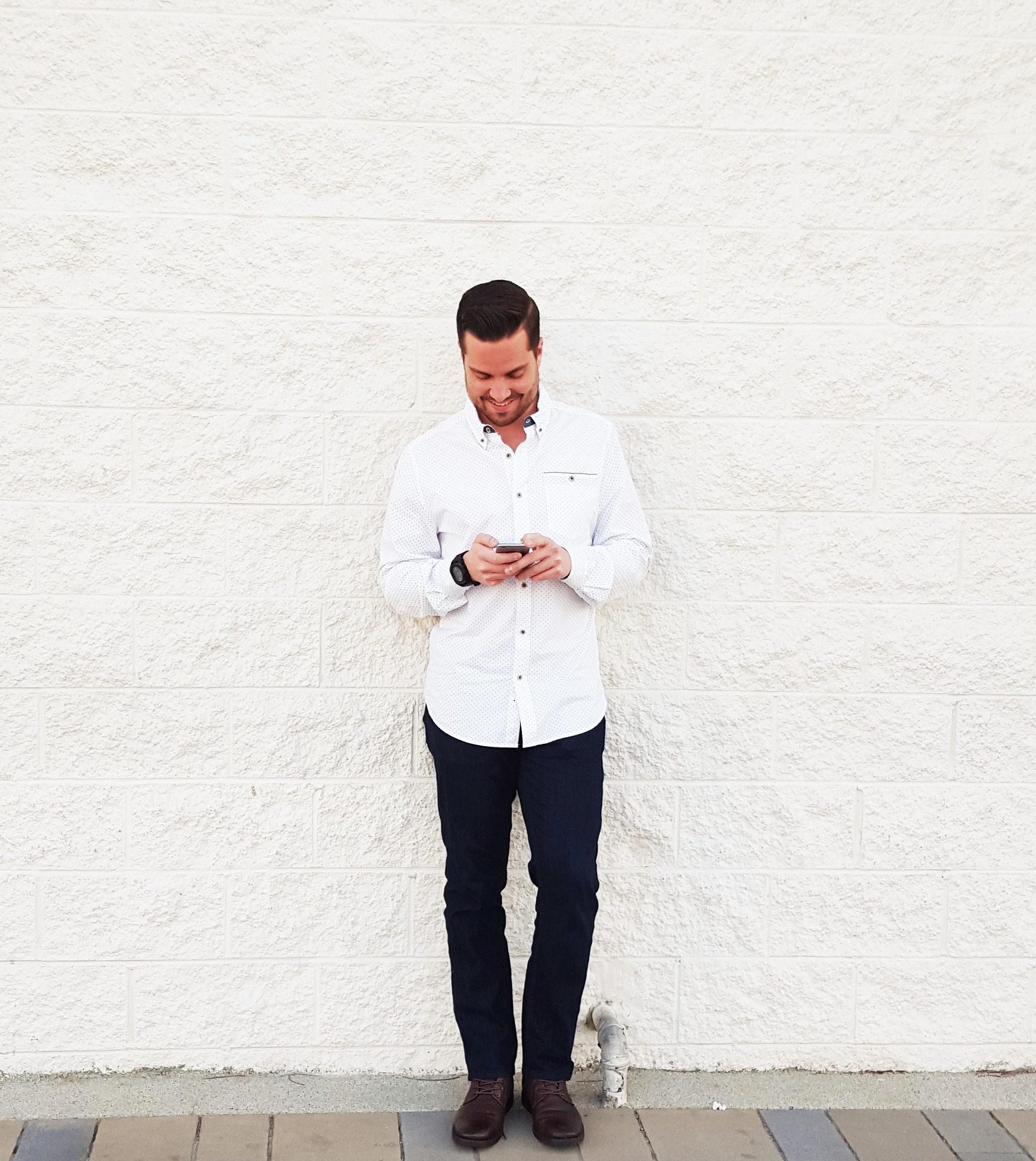 man smiling at his phone