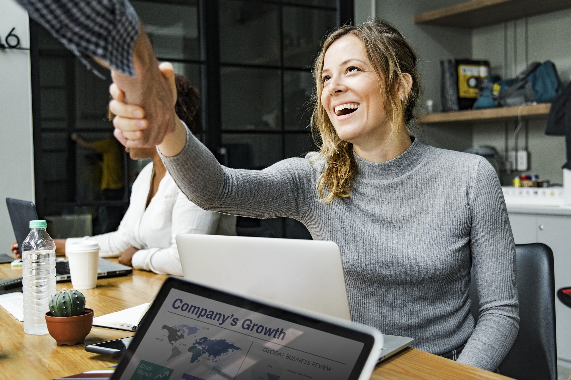 man shaking sitting woman's hand