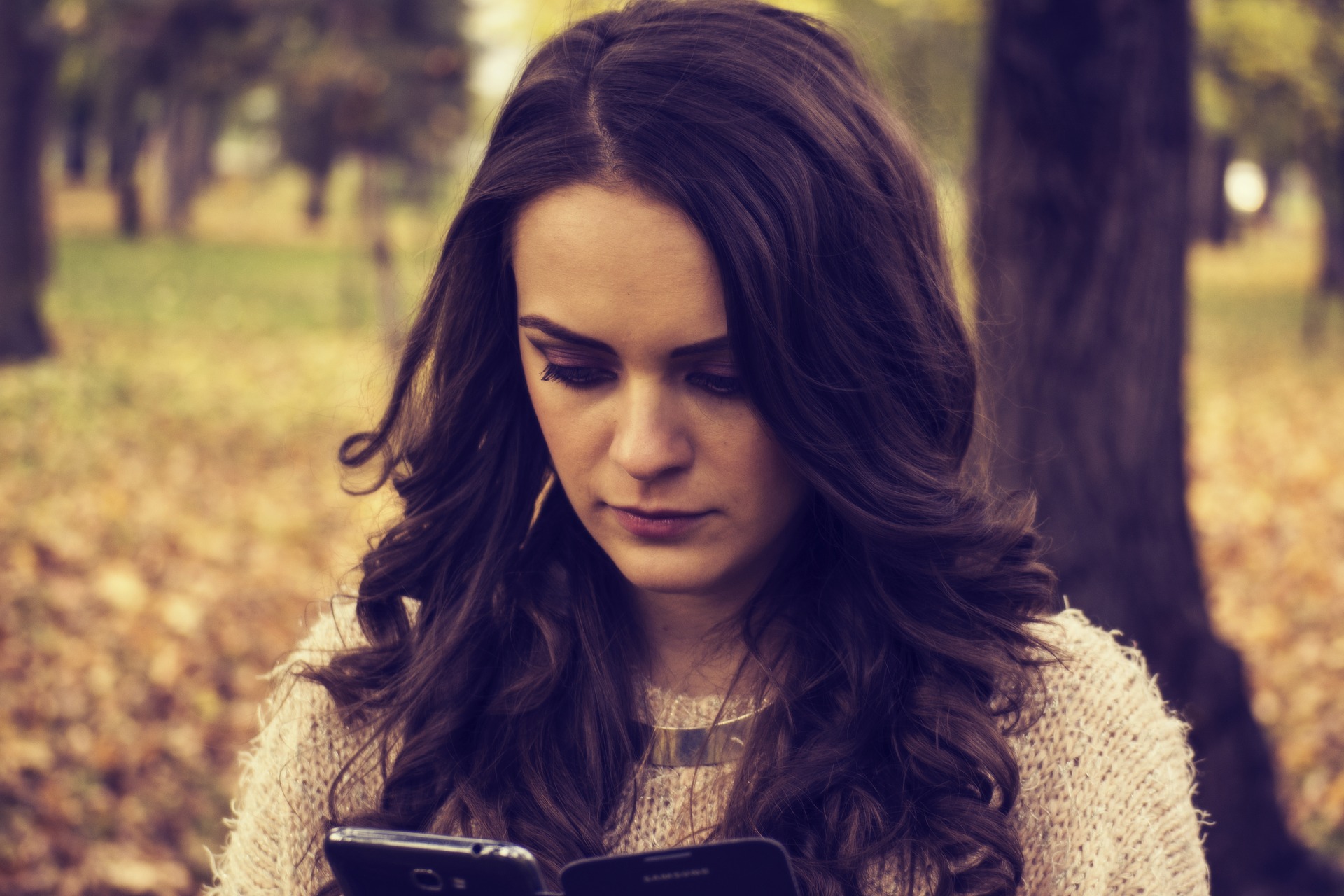 serious woman looking at phone