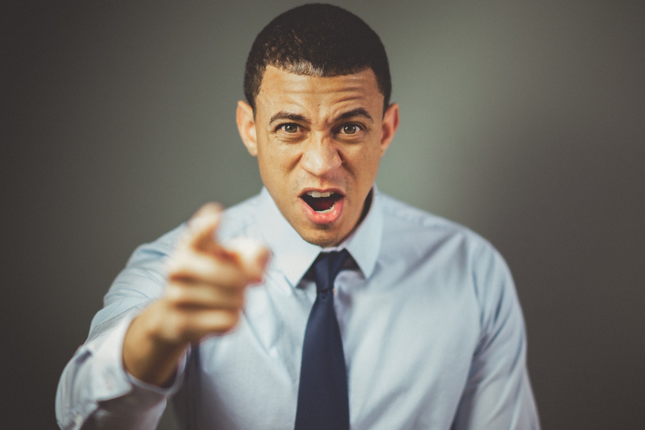 man in suit pointing